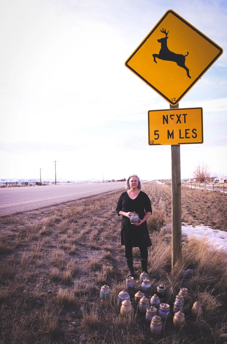 Artist Cristy Anspach on the 10-mile stretch of road near her home in Wyoming. For every animal hit on the road, she crafts a remembrance jar. (Photo GYC/Emily Reed.)