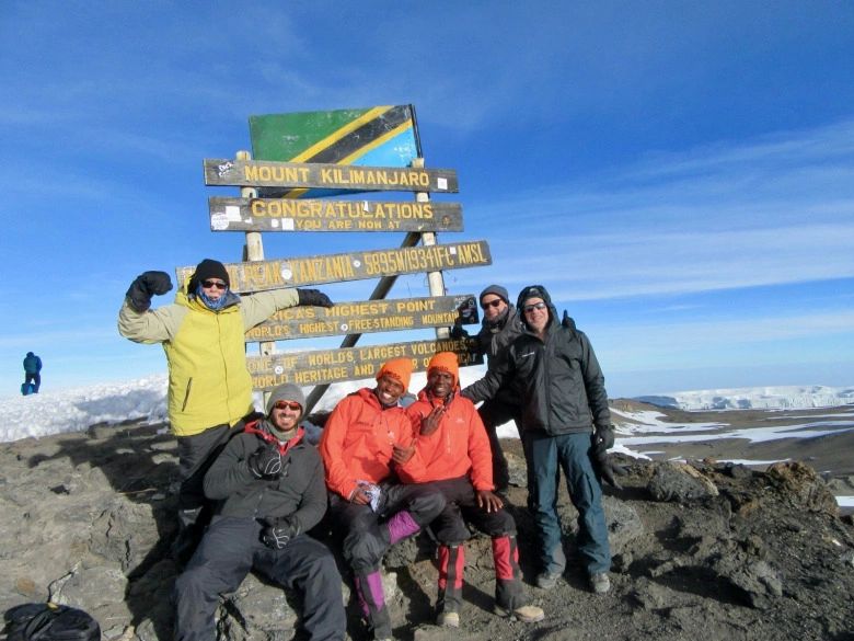 Only months ago, the author (in yellow jacket) and friends stood on the top of Mt. Kilimanjaro in Tanzania, at 19,341 feet the tallest summit in Africa. Like the still wildlife-rich Serengeti Plain, Knight says the diversity of wildlife in Greater Yellowstone, his home region, is a miracle that needs safeguarding. Photo courtesy Phil Knight