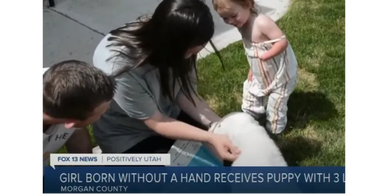 Special ability child receiving a special ability rescue puppy.