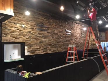 Stone veneer behind a bar and restaurant 