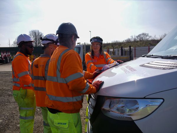 Staff discussing job around vehicle at  - Highway Assurance Ltd