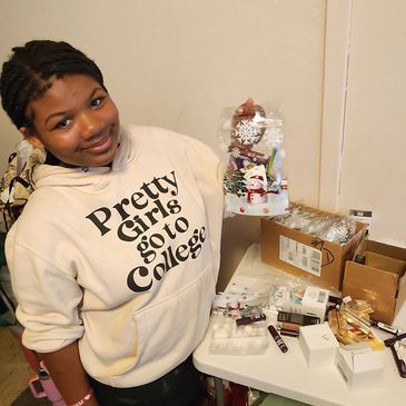 Smiling girl holding a holiday decoration.