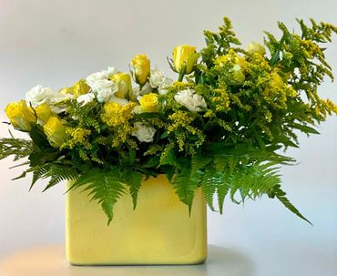 yellow roses in a yellow vase