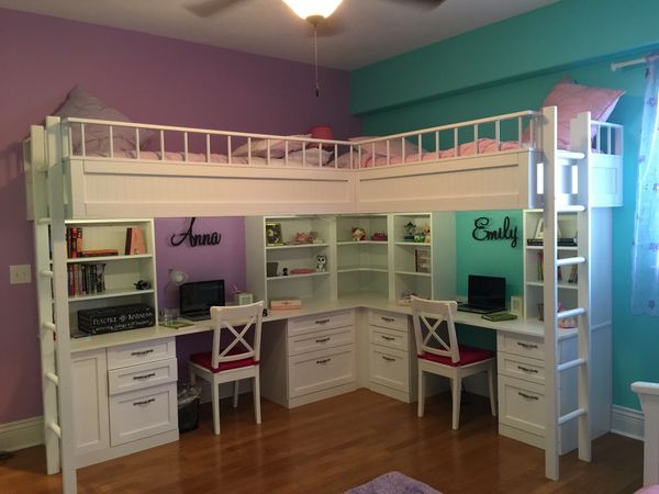 Loft bed with two study desks labeled Anna and Emily underneath.