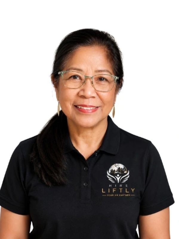 Smiling woman in glasses and black polo shirt.