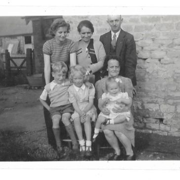 Black and white family photo with three generations.