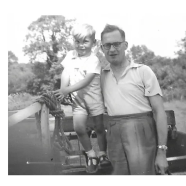 A man and a young boy posing together outdoors.
