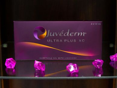 Juvéderm Ultra Plus XC box with decorative purple crystals.