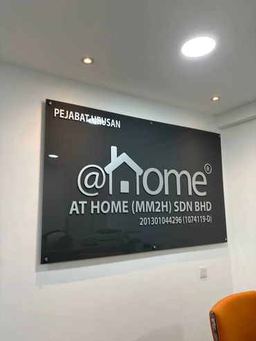 Office sign for AT HOME (MM2H) SDN BHD with a house logo.
