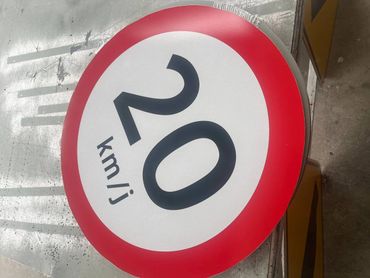 Round speed limit sign showing 20 km/h with a red border.