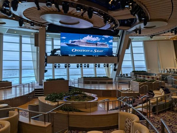 The Two70 lounge in the aft section of Ovation of the Seas with a 270 degree view of the ship wake