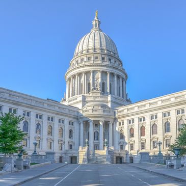 The majestic Wisconsin State Capitol under a clear blue sky.