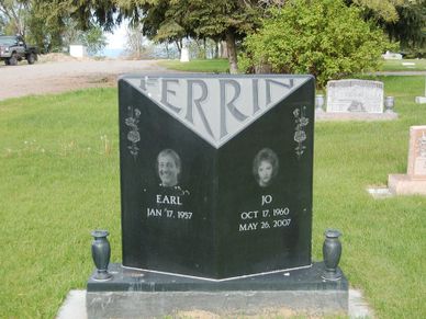 A unique V-shaped gravestone with portraits and dates for Earl and Jo.