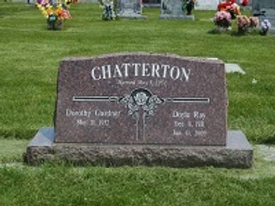 A cemetery headstone for Dorothy and Lloyd Chatterton in a grassy area.