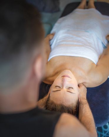 A woman getting a deep yet relaxing neck and shoulder treatment