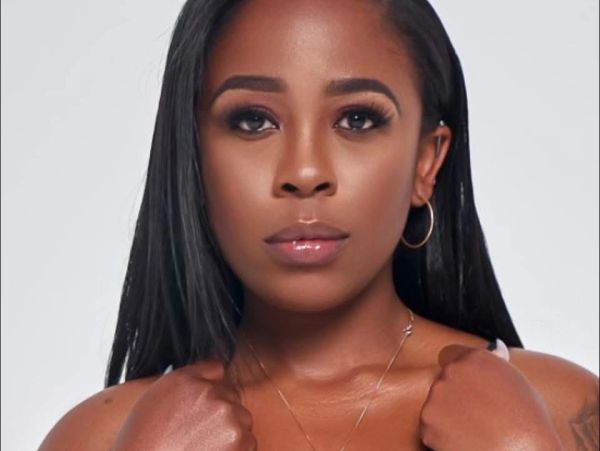 Confident woman with smooth skin and straight hair looking directly at the camera.