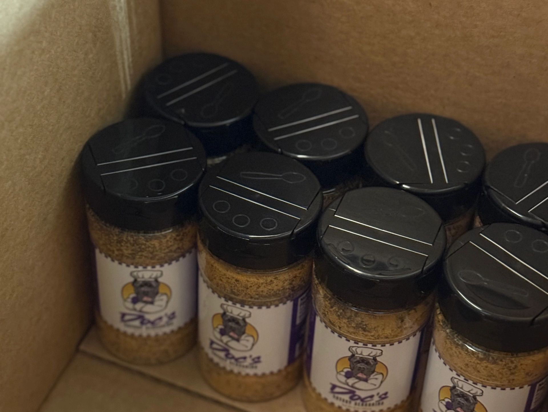 A box with 8 Doc's Savory Seasonings inside. Their logos are facing the camera.