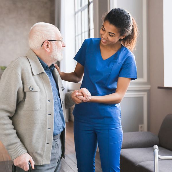 A nurse taking care of an elderly man