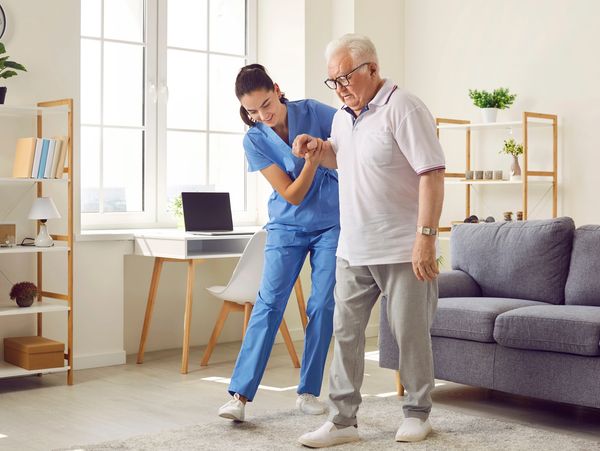 A nurse helping a patient walk