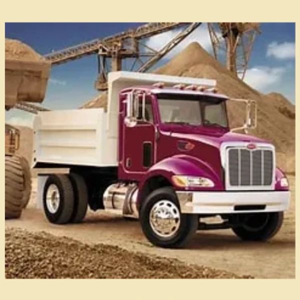 Purple and white dump truck at a construction site.