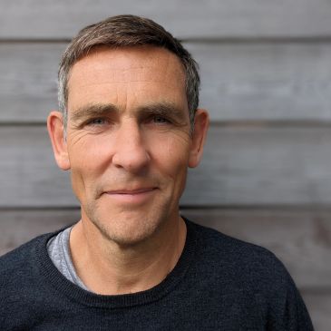 Middle-aged man with short hair and a slight smile.