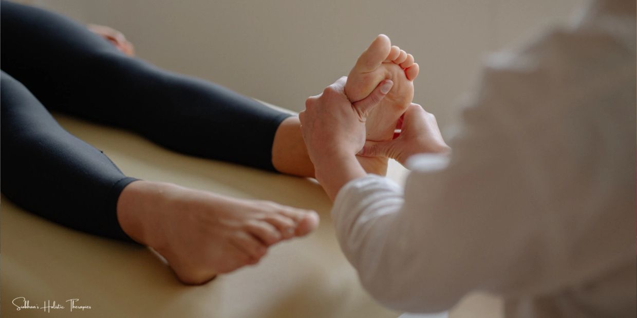 A woman performing reflexology