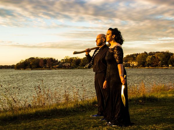 The Newlydeads standing near a lake looking into the sunset. 