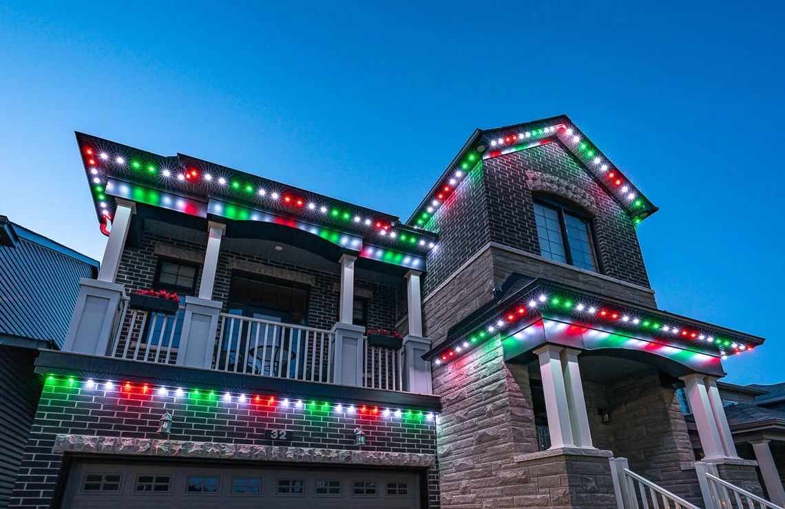 House decorated with red, green, and white Christmas lights.