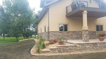 retaining wal, edgers, landscape rock, roses, feather red grass