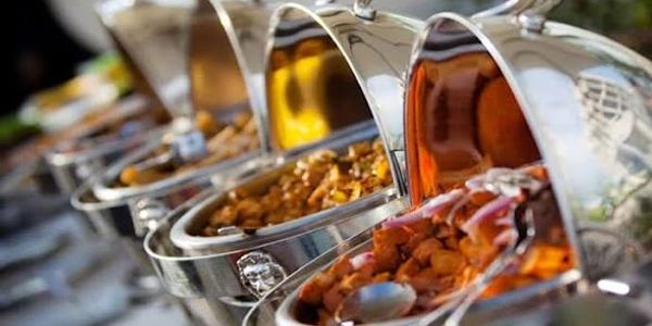 Chafing dishes filled with various cooked foods.