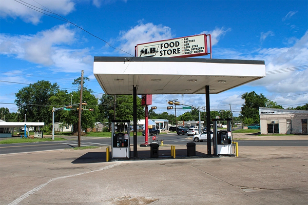 Covered gas pumps in front of MB Food mart in Lufkin Texas