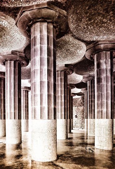 Stone columns with mosaic ceilings in an architectural setting.