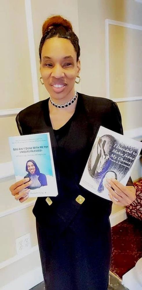 Sherria Young - holding 2 books that she published