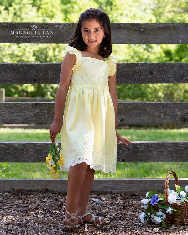 Portrait of a young girl in a yellow dress