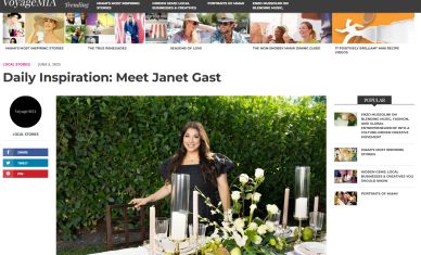 Janet Gast stands behind an elegant outdoor table setting with candles and flowers.
