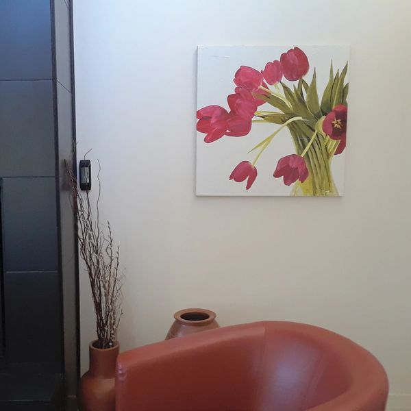 The oil painting of red tulips from the home screen, hanging in the artist's home as described here.