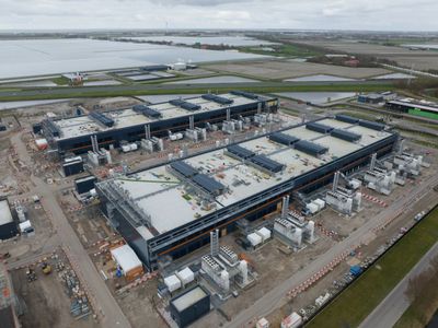 A large data center complex under construction in a rural area.