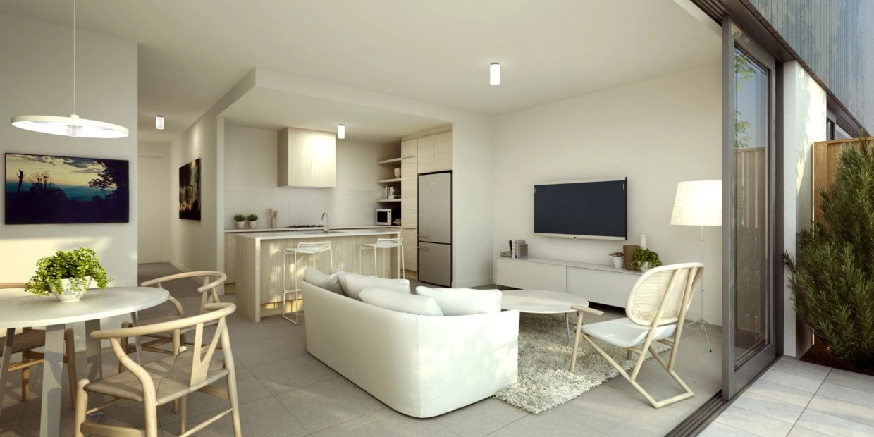 Bright modern living room with kitchen and outdoor access.