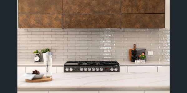 Modern kitchen with a sleek gas stove and brown cabinets.