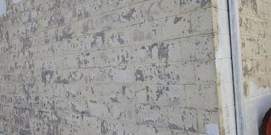 old chipping paint on a cinderblock wall