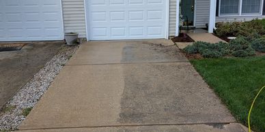 a half powerwashed driveway