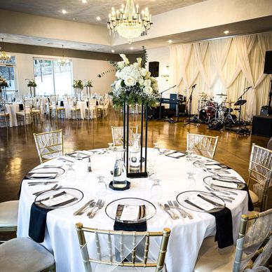 Elegant round table set for an event with floral centerpiece.
