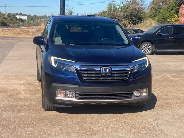 Front view of a blue Honda SUV parked outdoors.