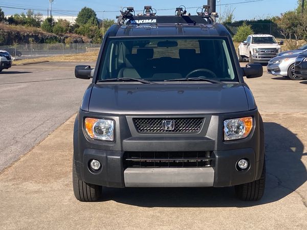 Front view of a black Honda Element parked in an outdoor lot.