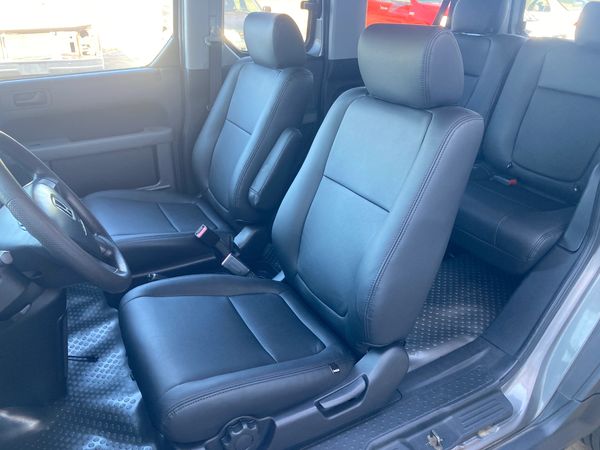 Clean black leather car seats inside a vehicle.