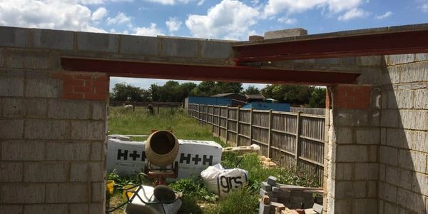 the start of a two story extension blockwork and steels with a large opening 