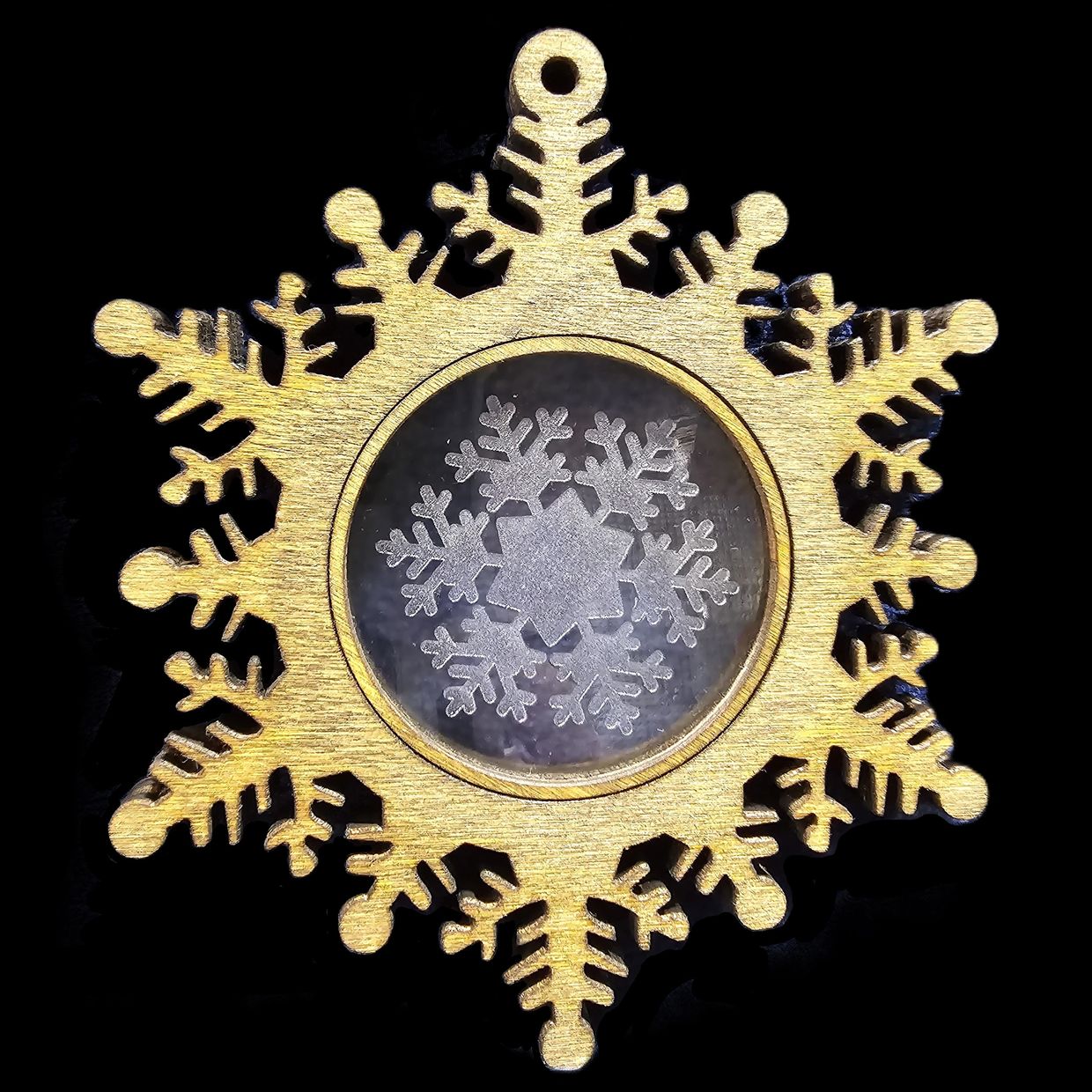 Laser cut wooden snowflake with acrylic insert.