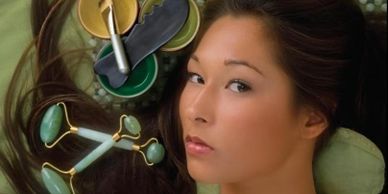 woman with jade roller by her face