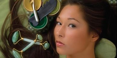woman with jade roller by her face