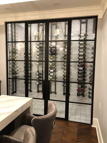 Wine storage room with glass doors and window walls